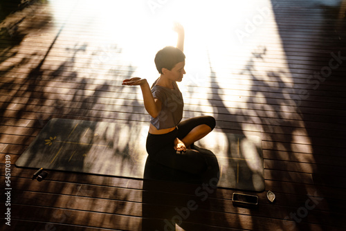 Konstfotografi White brunette woman doing exercise during yoga practice outdoors