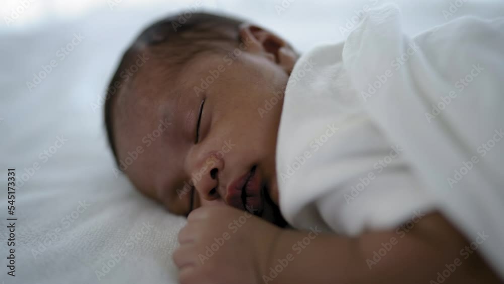 Closeup portrait of african happy baby sleeping sweet dream on bed over white background with copy space. Healthy newborn child take a nap asleep. Family love newborn healthcare medical concept. Closeup portrait of african happy baby sleeping sweet dream on bed over white background with copy space. Healthy newborn child take a nap asleep. Family love newborn healthcare medical concept.