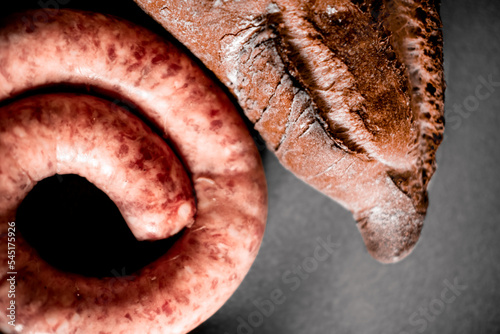 фотография Top View Of Uncooked Spanish Sausage Or Longaniza And Artisanal Bread