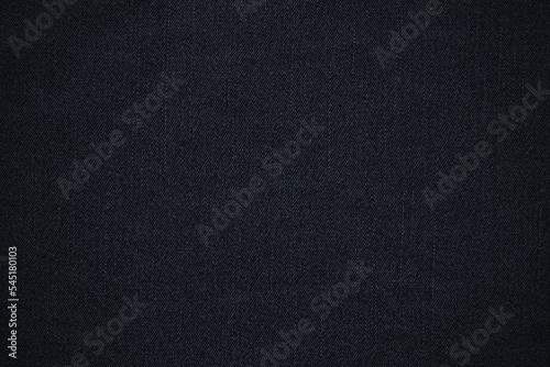 texture of black colored jeans denim fabric background 