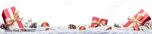 A festive Christmas banner of a winter landscape with presents and decorations in the snow isolated against a transparent background. © Duncan Andison