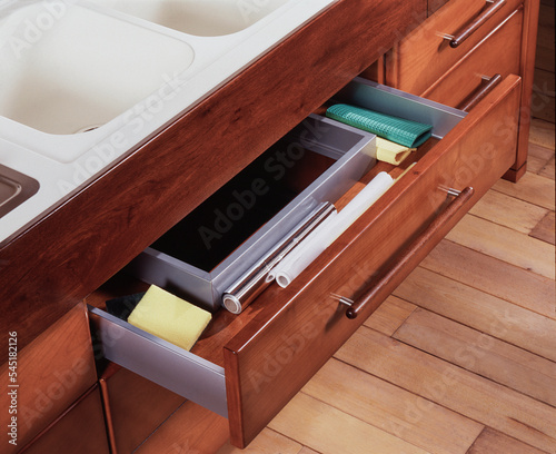 Detail of an equipped basket  of a modern wooden kitchen