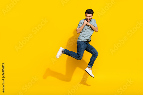 Full length photo of overjoyed man wear trendy clothes hold empty space black friday shopping sale isolated on yellow color background © deagreez