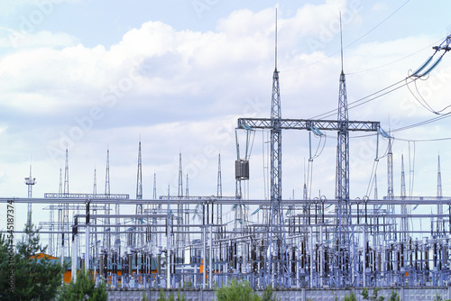 High and low electric poles against the sky with white clouds. High quality photo