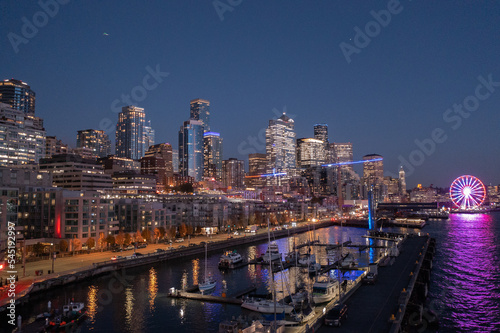 night aerial view of illuminated Seattle Downtown and the Waterfront pier area with The Seattle Great Wheel - aerial night view 