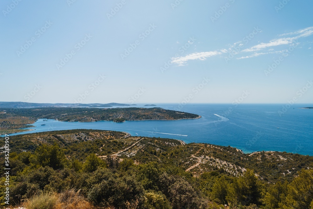 Scenic view of the beautiful landscape of Primosten, Croatia against a blue sky