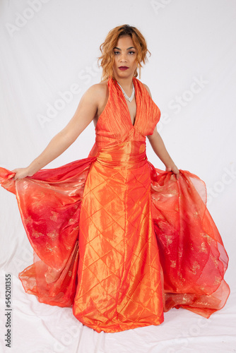 Beautiful woman in a long, flowing orange dress