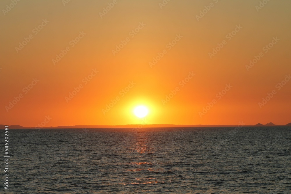 Beautiful orange sunset over gray sea dines, perdect for wallpaper