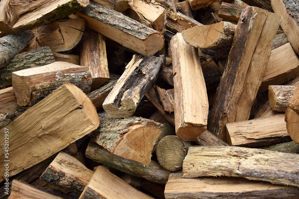 Lots of chopped oak firewood. Natural background. Lots of chopped oak firewood. Natural background.