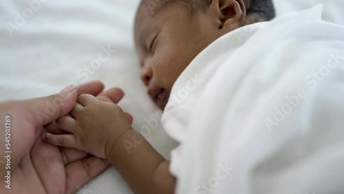 Parent hands holding newborn african black baby fingers, Close up mother's hand holding their new born baby. Together love family healthcare and medical, father's day and mother's day concept.