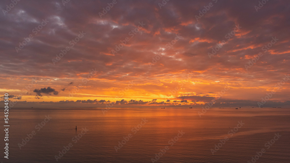 Amazing sunrise and beautiful colors in the cloudy sky. Baltic. View from the drone.
