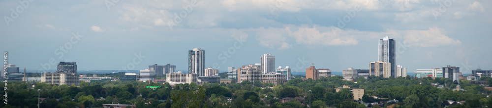 panoramic skyline of Kitchener, Ontario, Canada with fall colored trees and several buildings 