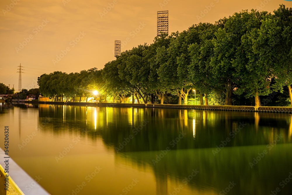 Lake with green trees at the evening