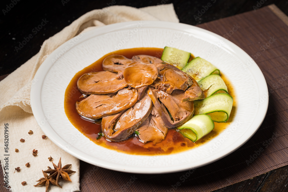 Special Chinese food braised pork heart on retro background Special Chinese food braised pork heart on retro background