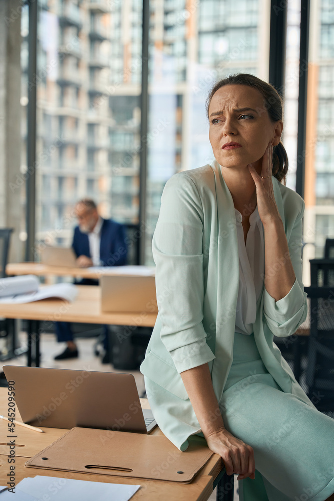 Obraz premium Serious female working in office with colleague