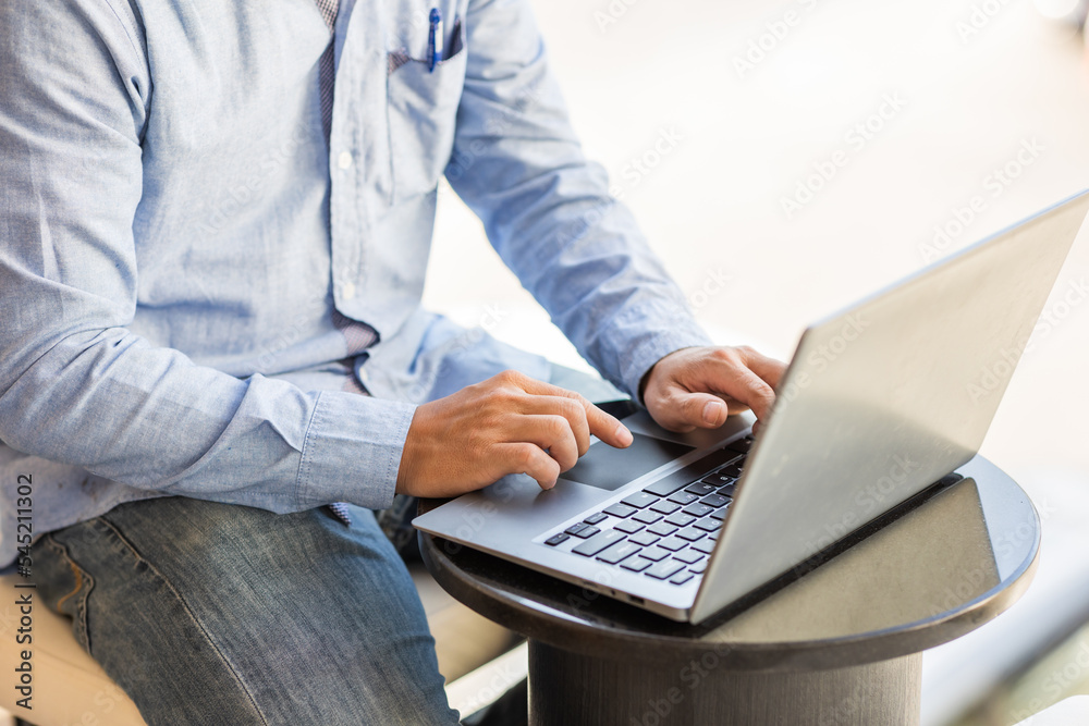 Side view of male businessman hands typing on laptop keyboard. Side view of male businessman hands typing on laptop keyboard.