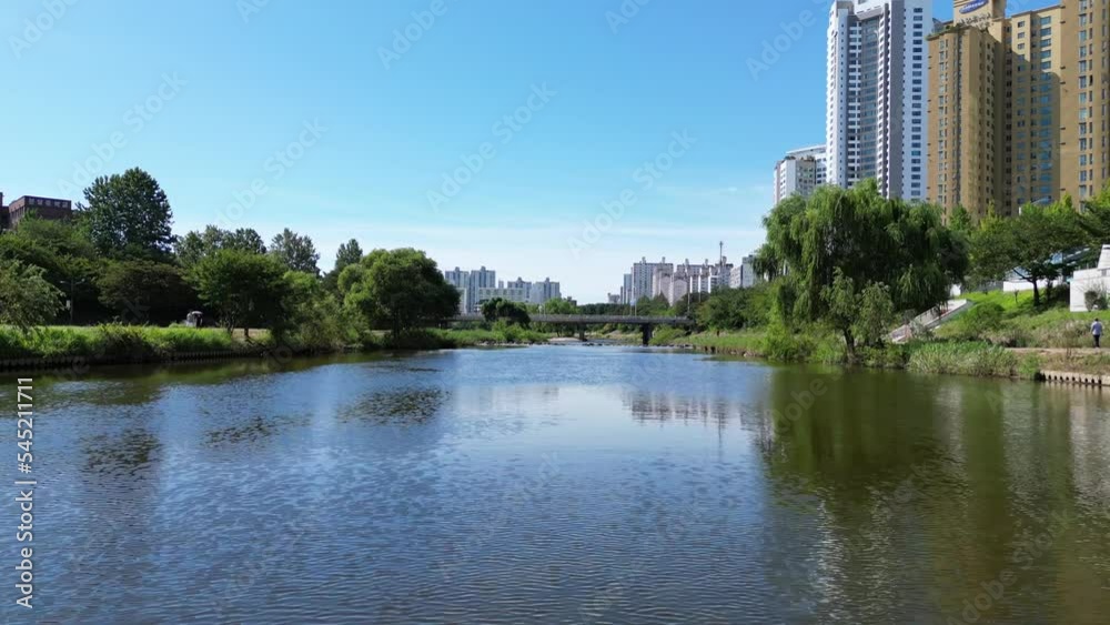 Panoramic view of a cityspace with a beautiful river on the front and skyscrapers in the background Panoramic view of a cityspace with a beautiful river on the front and skyscrapers in the background