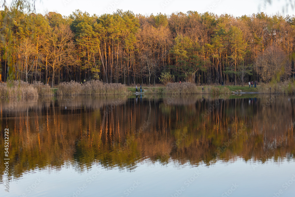 Stunning photo of fall foliage reflected on a lake with a glass like mirror water surface