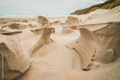 Closeup shot of big frozen sand pile sculptures on the coast near the sea