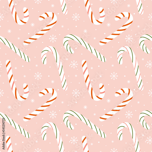 Seamless Christmas and New Year pattern. Coffee cane on a light pink background.