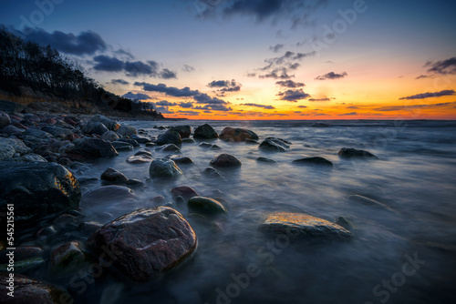 Wonderful orange sunset on the rocky coast of the sea © Dmitriy Popov