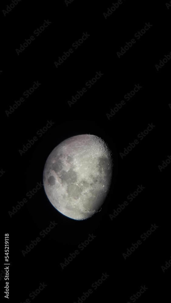 Vertical zoomed-in shot of the moon in the night sky Vertical zoomed-in shot of the moon in the night sky