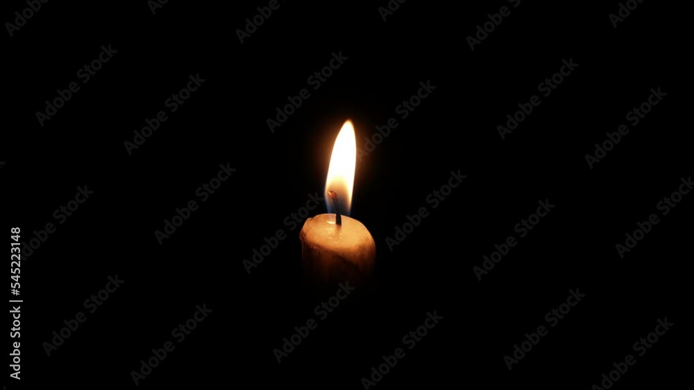 Burning candle flame with smoke on dark background. Mourning concept. Burning candle flame with smoke on dark background. Mourning concept.