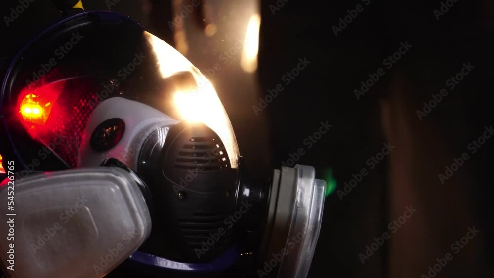 Man wearing protective suit and gas mask standing in fog Man wearing protective suit and gas mask standing in fog