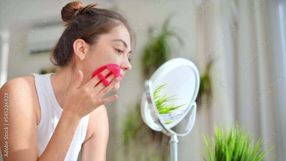 A young caucasian woman with patches under her eyes looking into the camera. Skin care theme A young caucasian woman with patches under her eyes looking into the camera. Skin care theme