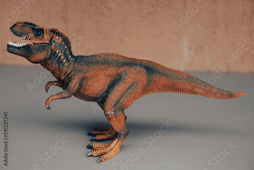 Tyrannosaurus Rex. Side view of a fierce T-Rex dinosaur. Tyrannosaurus was a bipedal carnivore with a massive skull. Exist before the Cretaceous-Paleogene extinction event.