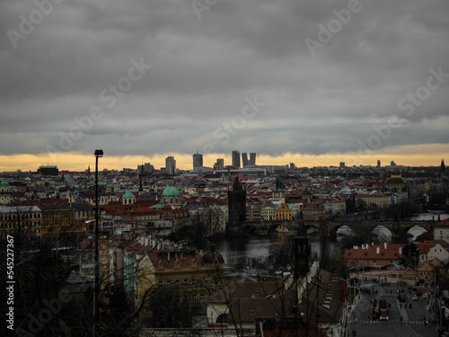 Aerial view of Prague cityscape during dark gray cloudy sunset on a gloomy day
