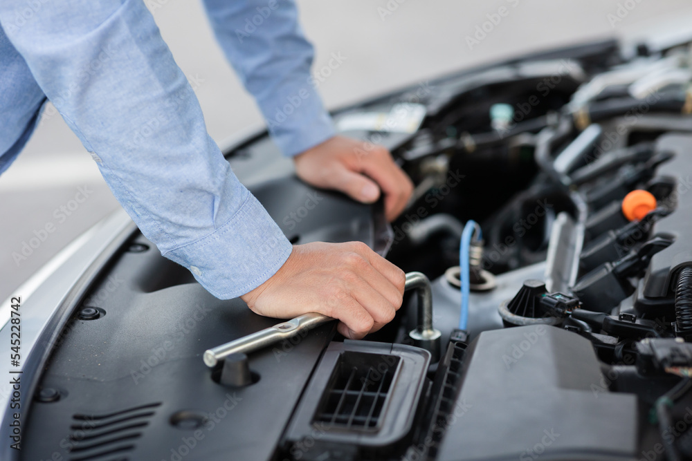 Man with checking car engine. Man with checking car engine.