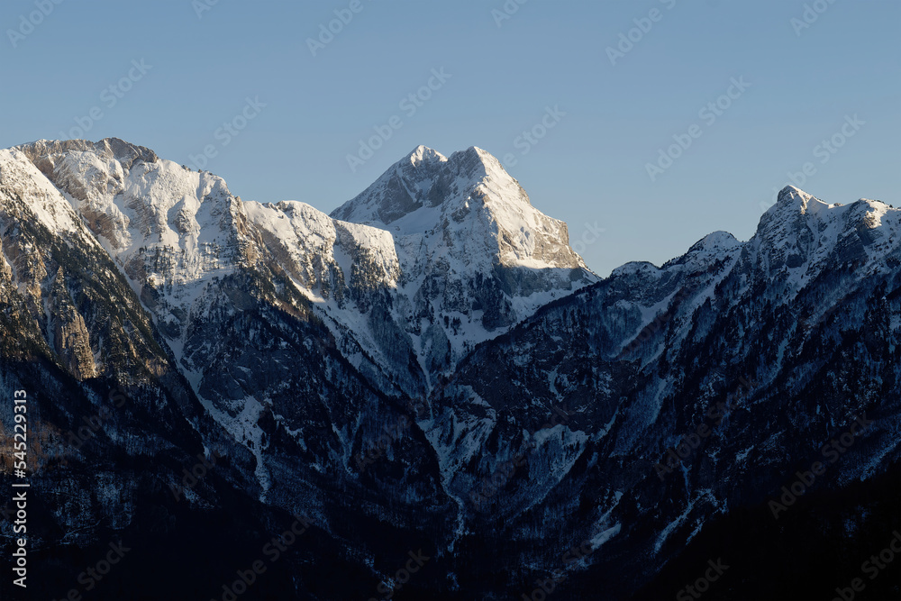 Amazing view of a mountain peak during sunset. Summit of difficult access for climbers. Alpinism and climbers. Blue sky and vibrant colors. Cinematic shot. More adventure in life. Prenj Mountain.
