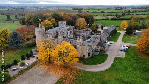 Aerial view of Walworth Castle with colorful autumn trees and parked vehicles in England photo