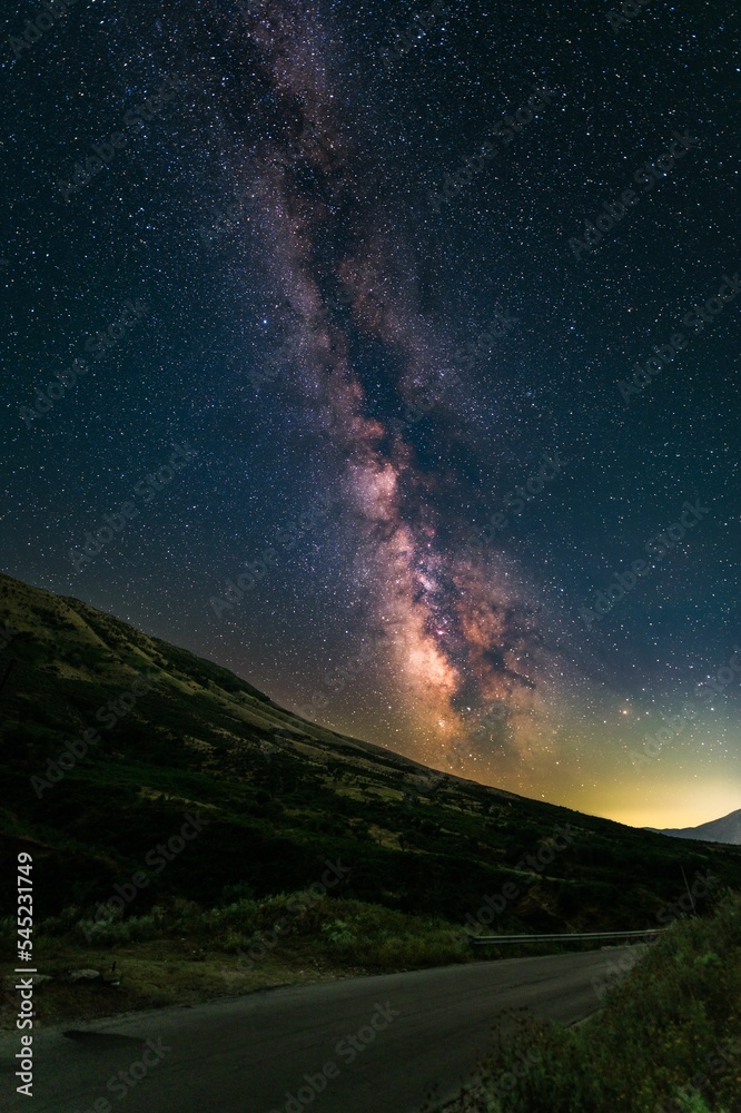 Beautiful view of the Milky Way galaxy above horizon seen from the dark skies of a road in Albania