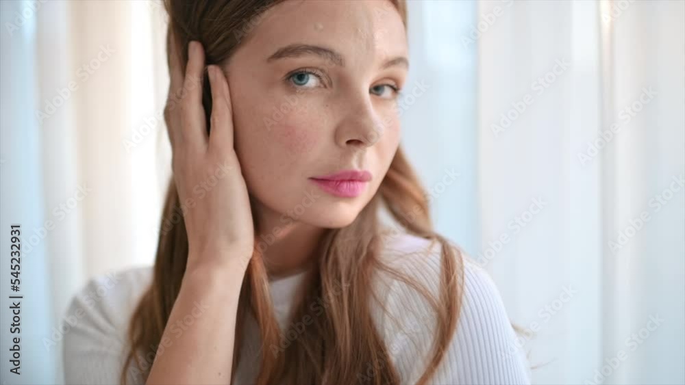 A young caucasian woman is doing a facial massage A young caucasian woman is doing a facial massage