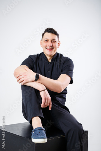An adult man of European appearance wearing a black medical suit © Дмитрий Ткачук