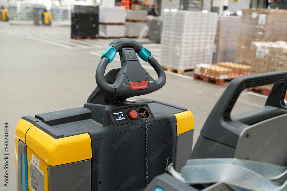 Steering wheel or gear of a Electric pallet truck or forklift loader or tractor in a distribution warehouse Steering wheel or gear of a Electric pallet truck or forklift loader or tractor in a distribution warehouse