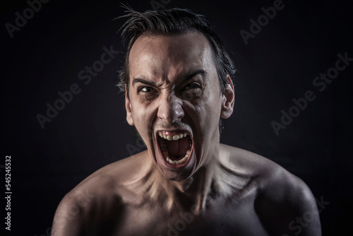 Dramatic screaming, young man completely mad with rage and fury