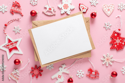 Christmas composition with a kraft envelope and red and white Christmas tree toys