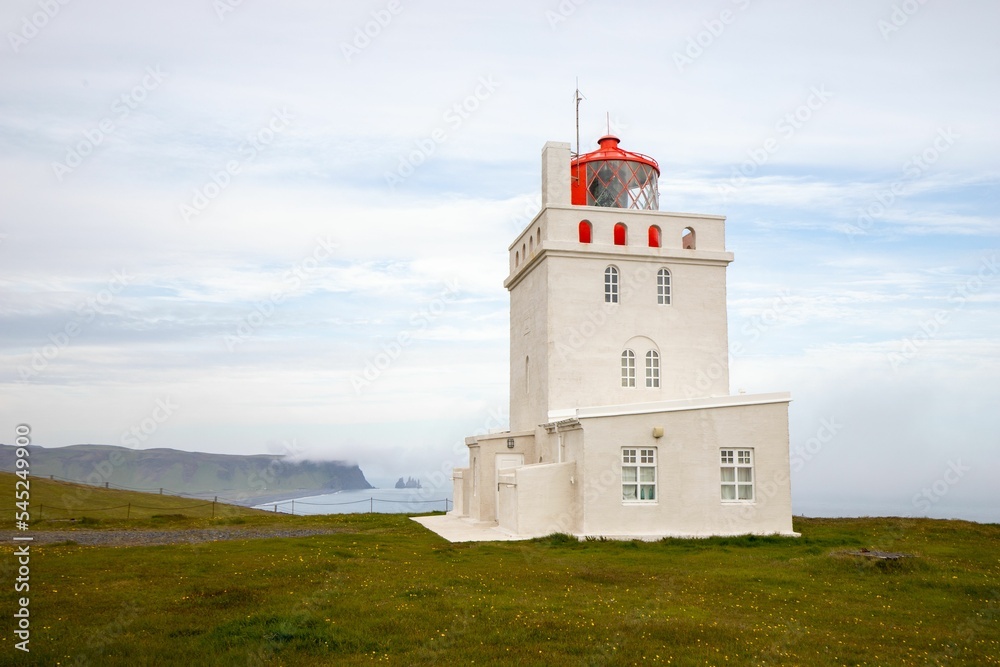 Lighthouse of the Dyrholaey promontory on the coast of Iceland Lighthouse of the Dyrholaey promontory on the coast of Iceland