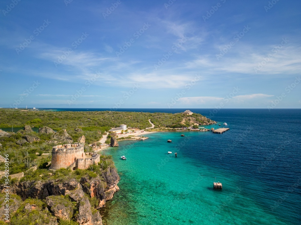 Fototapeta premium Aerial shot of the scenic Caracas Bay in Willemstad Curacao with blue seawater and skyscape