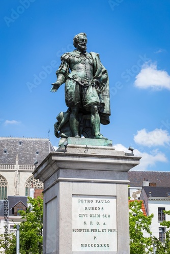 Vertical shot of the beautiful statue of Peter Paul Rubens against a blue sky in Antwerp, Belgium photo