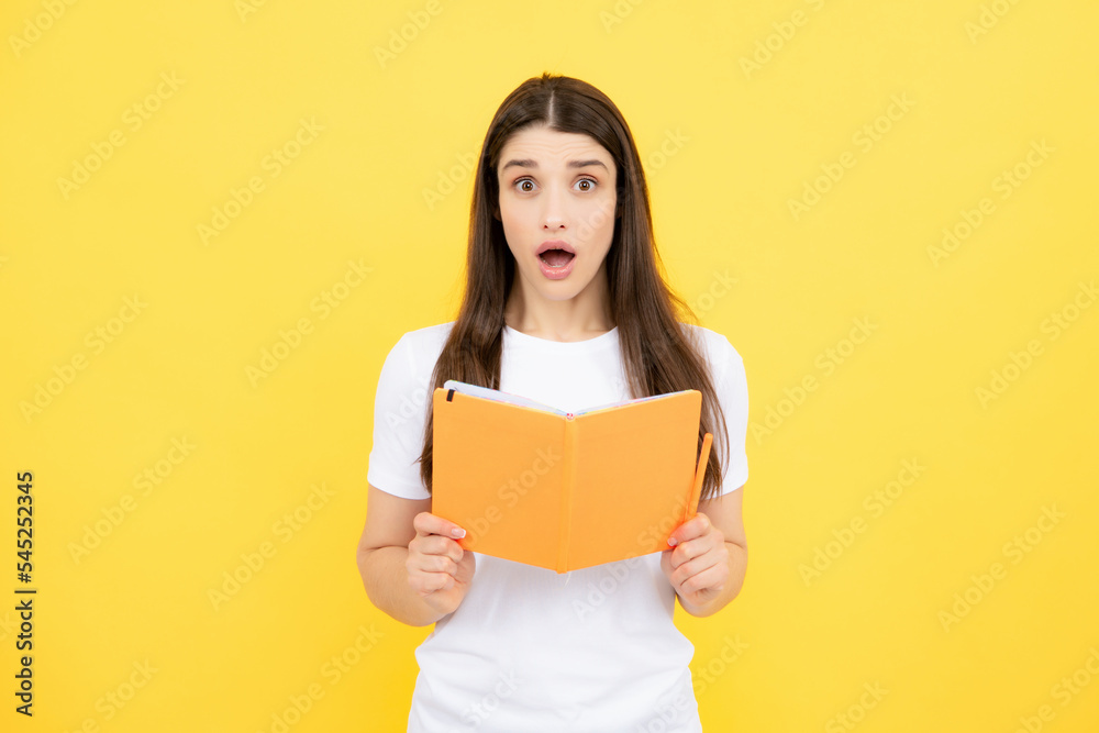 Teenager student girl isolated on yellow background. Cheerful young woman student in shirt hold notebooks showing. High school university college students. Teenager student girl isolated on yellow background. Cheerful young woman student in shirt hold notebooks showing. High school university college students.