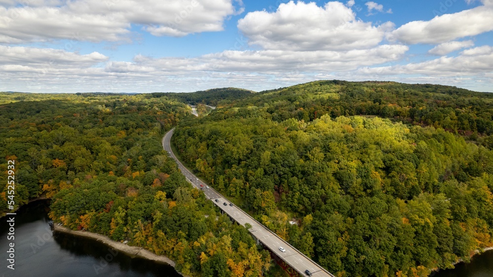 Drone shot of a bridge over the New Croton Reservoir on a sunny day in autumn