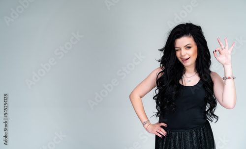 Attractive female model posing signing. Portrait of pretrty young brunette woman.