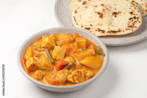 Mix vegetable curry - Indian main course recipe contains Carrots, cauliflower, green peas and beans capsicum and paneer with traditional potato with roti or chappati naan or Indian bread 