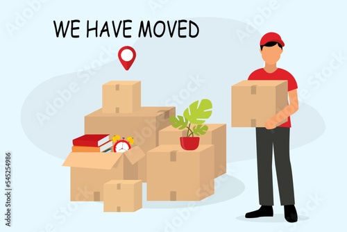 We have moved, changed address. We have moved concept. Moving with boxes. Things in box. Transport company. Moving to new office. Pile of stacked cardboard boxes. Moving to new house