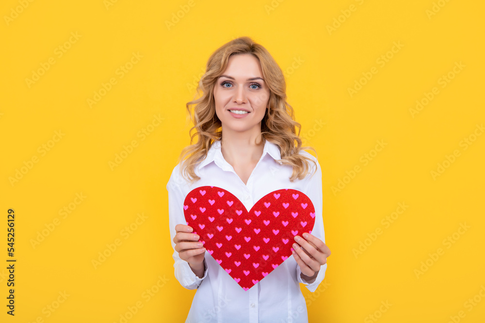 happy woman with red love heart on yellow background