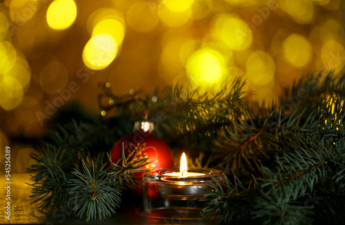 Christmas burning candle, sparkling and fabulous background with copy space. Christmas background for postcards. Christmas decoration concept.